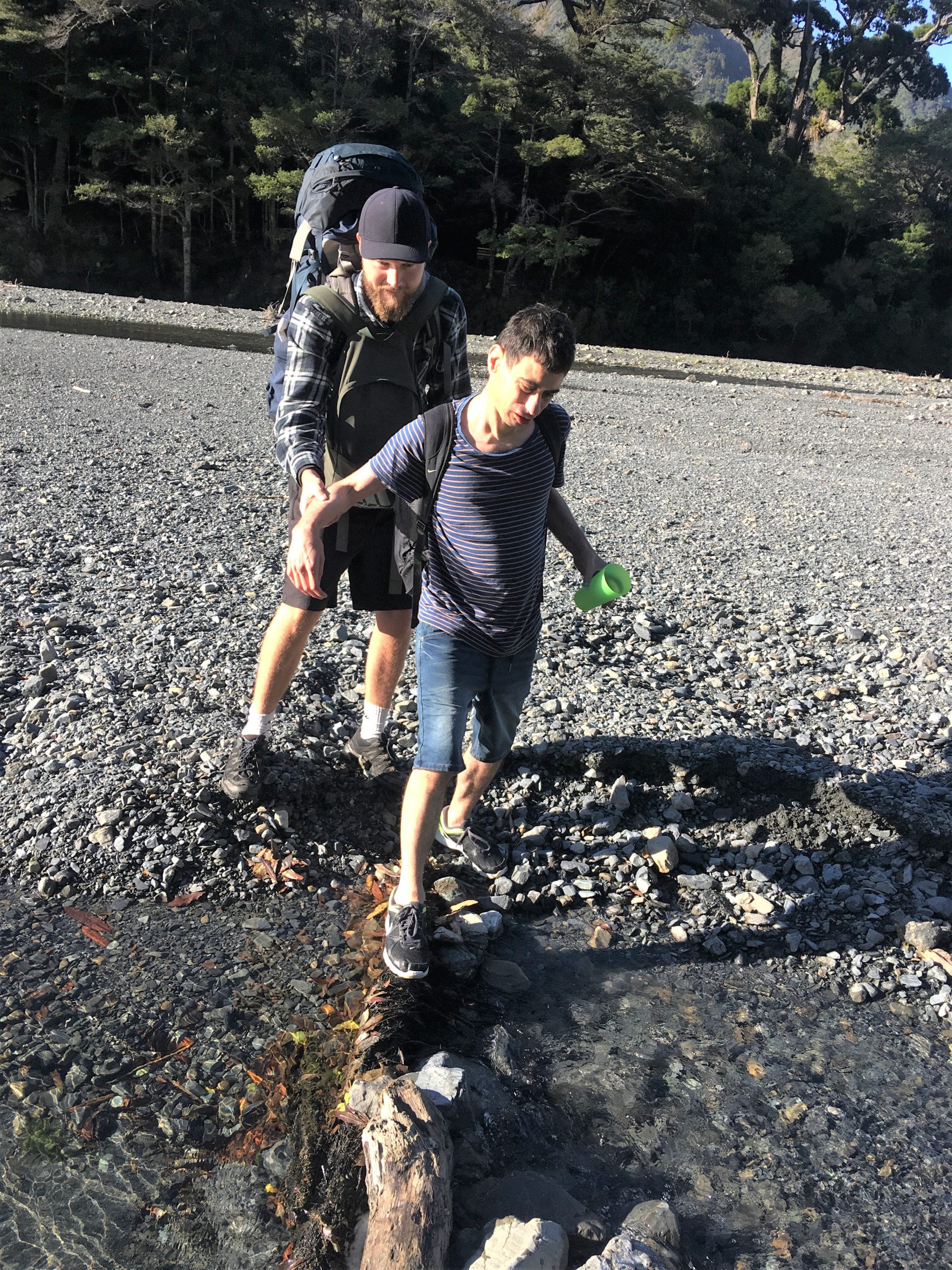 Harry (back left) guiding Nik (front) across difficult terrain