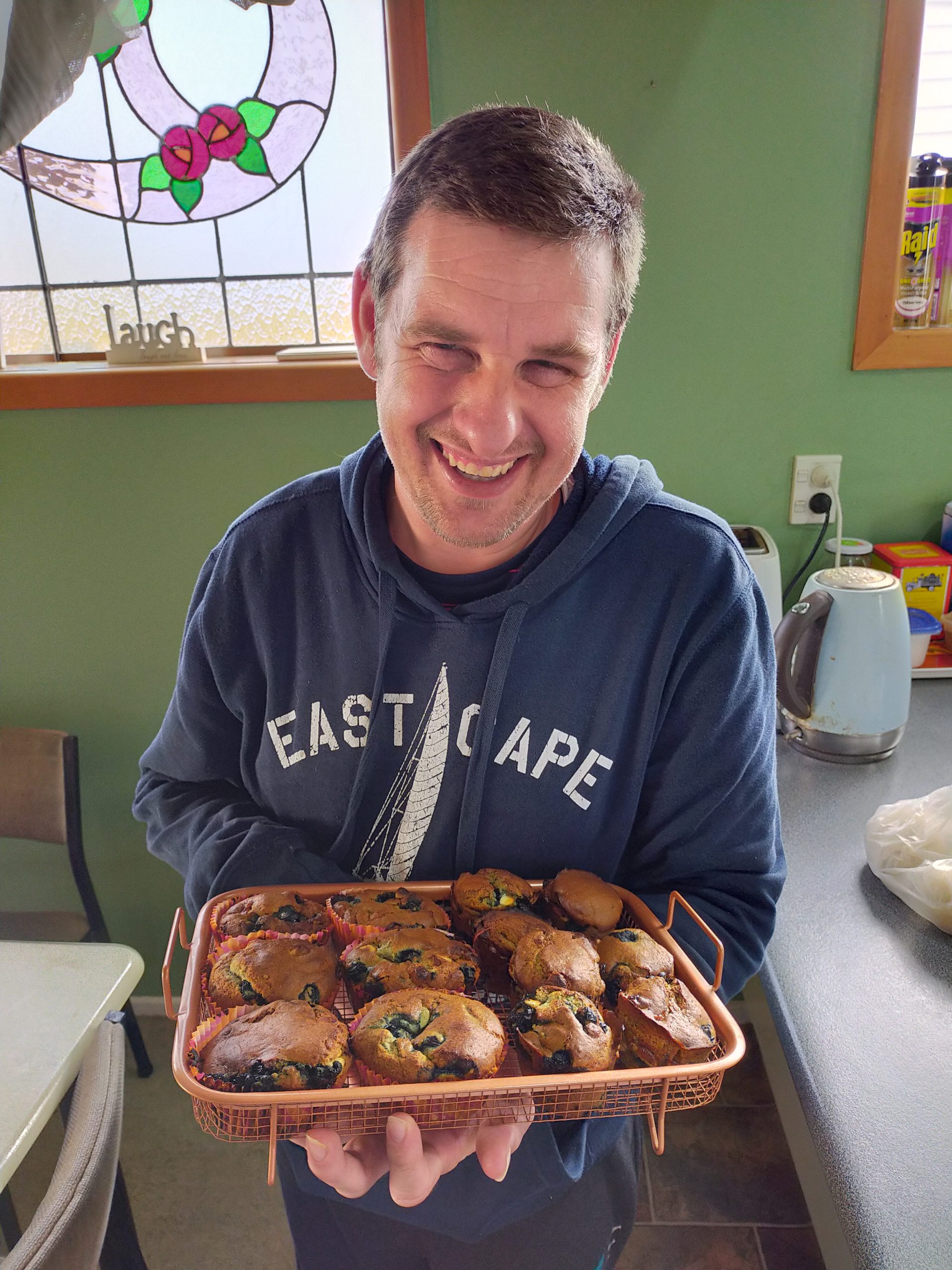 Jeremy and his muffins Jeremy holding up a tray of freshly baked muffins
