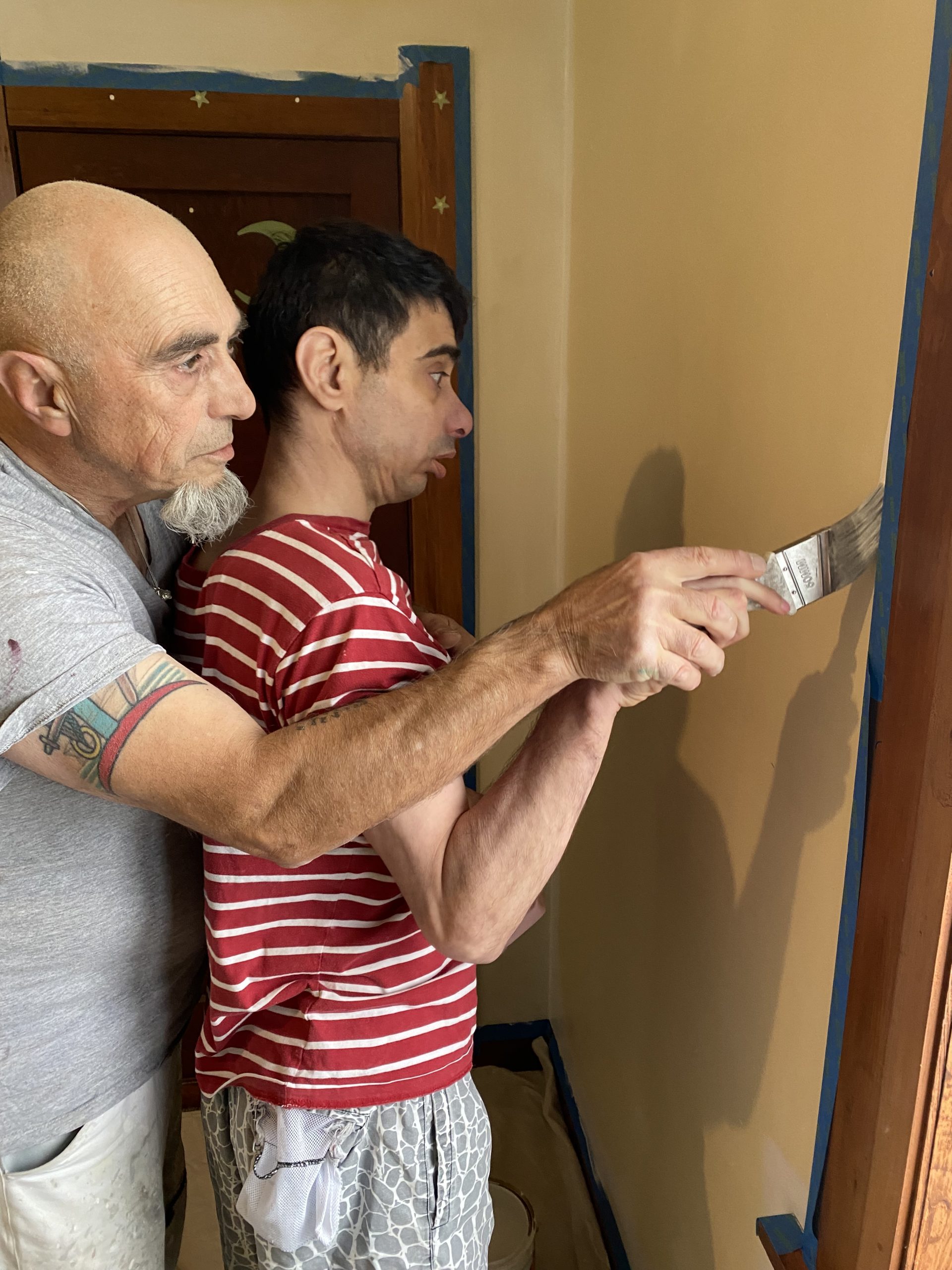 Nik painting with his dad Nik painting with support from his dad
