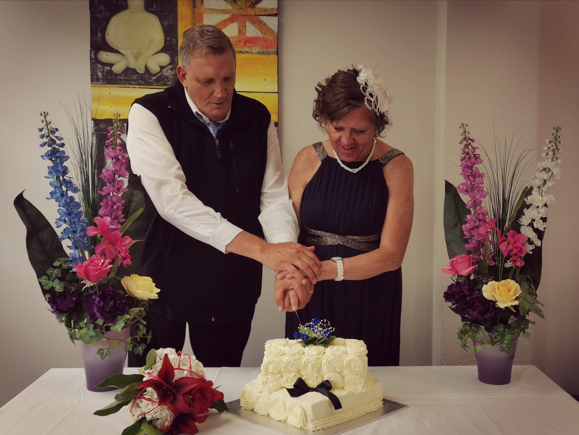 Paul and Pip Cutting Cake Paul (left) and Pip (right) both holding a knife cutting their cake