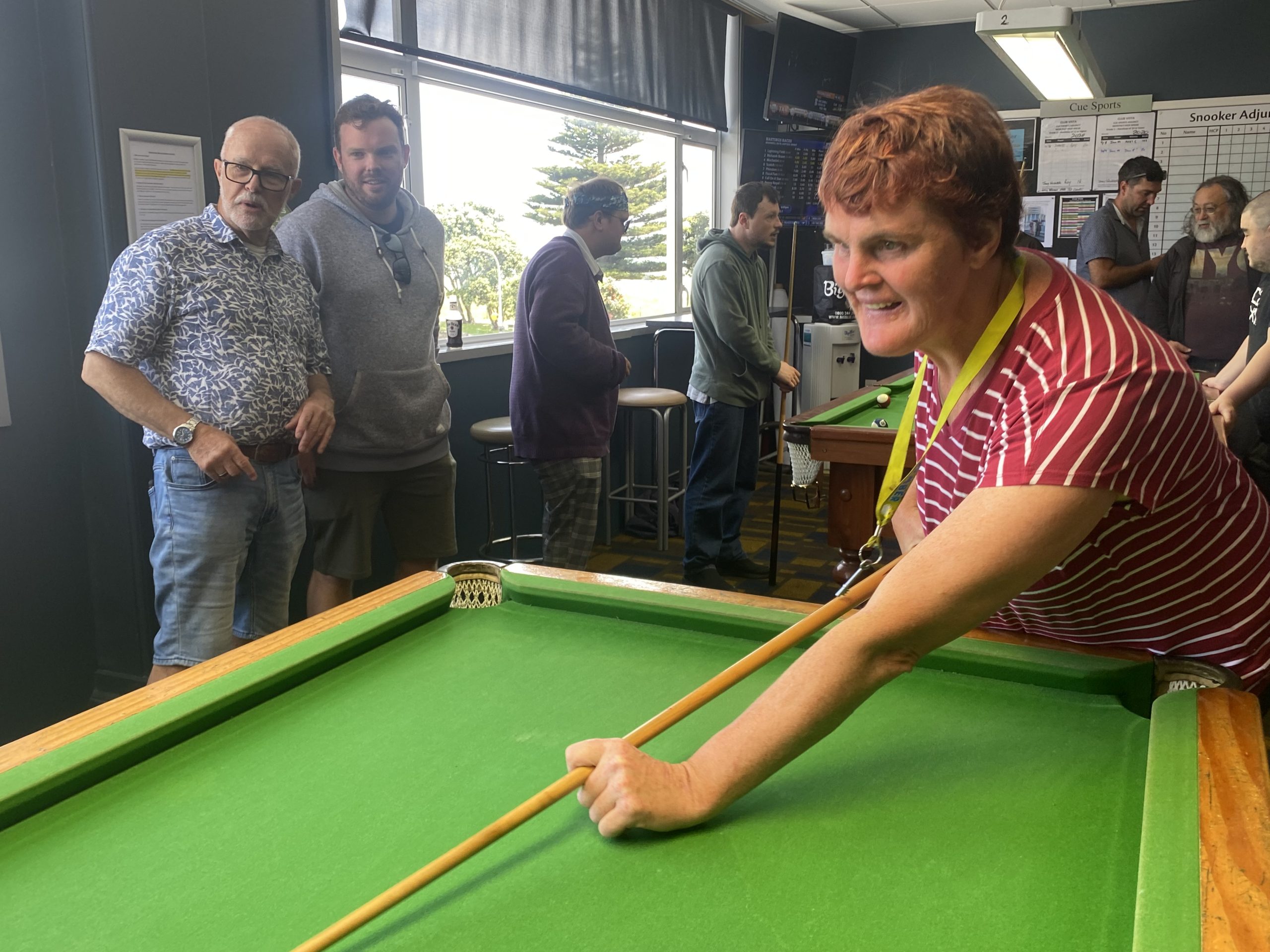 Trish (right) taking a shot in pool