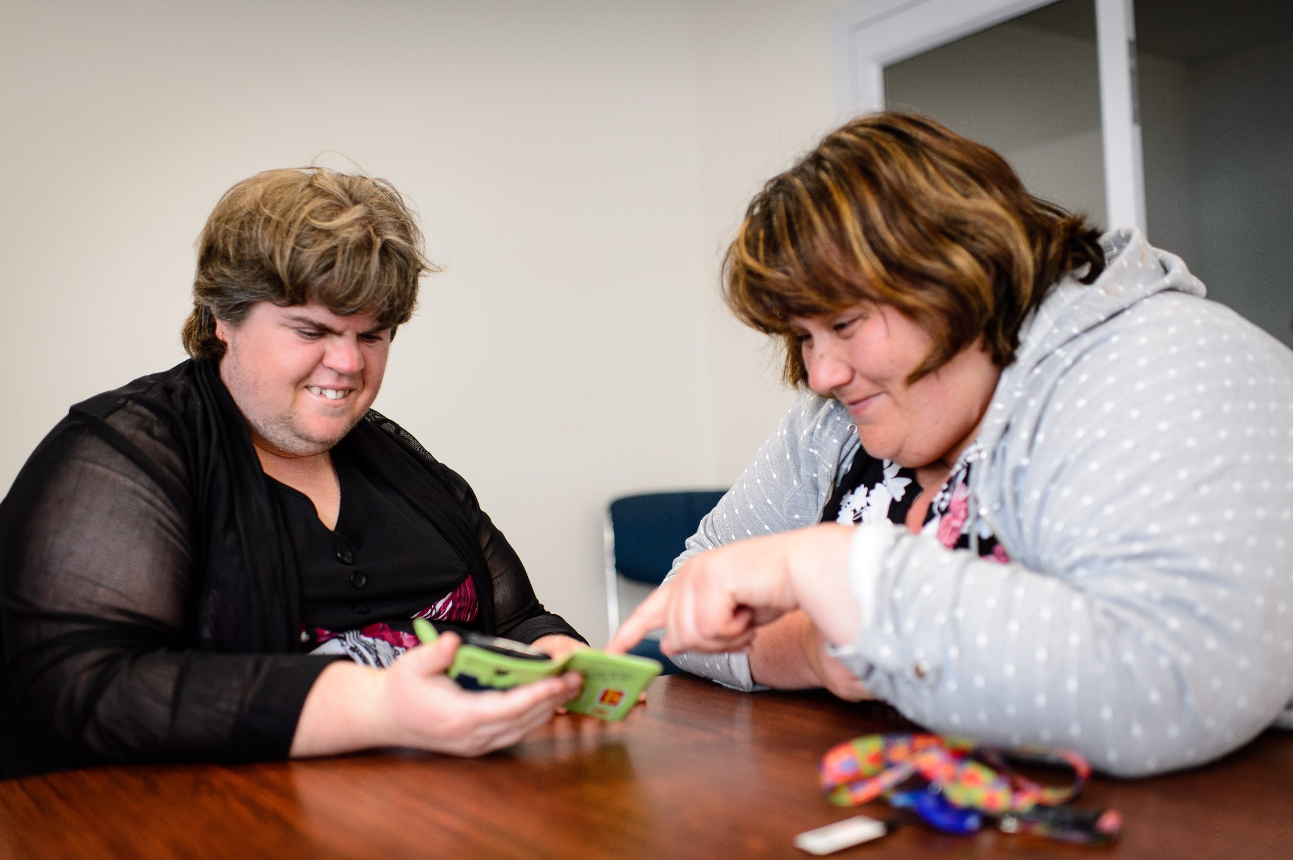 Alison (left) showing Jenna content on her smart phone