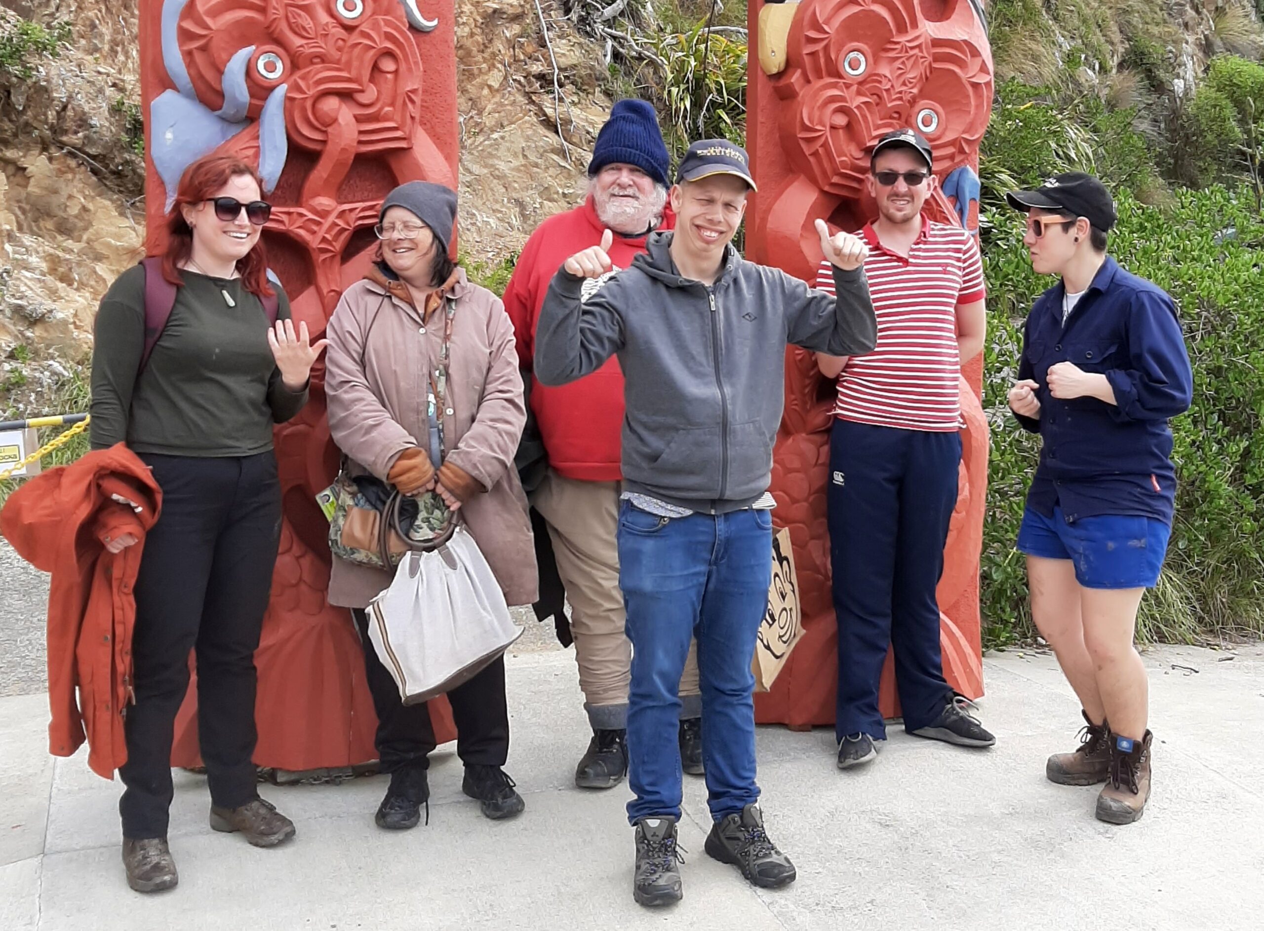 Group of people by carved images on Matiu Island